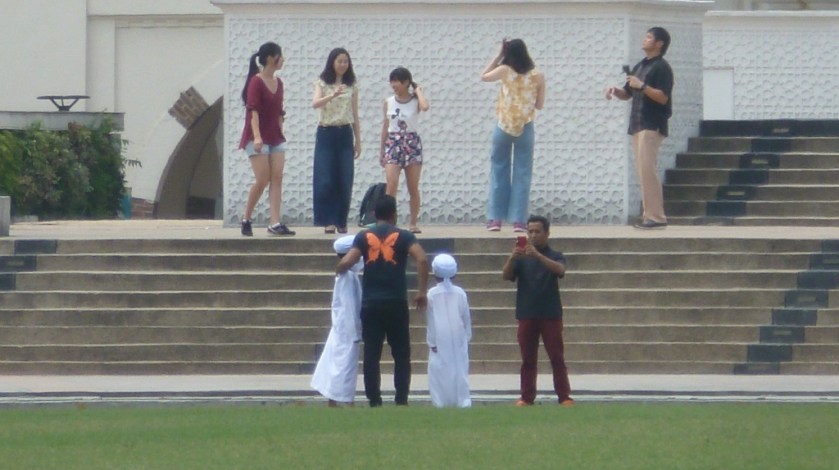 Those little boys are so cute in their traditional dress.