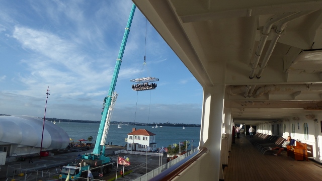 We watched a crane lift it into the air.