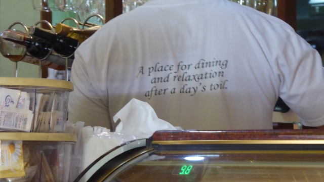 The Restaurante delle Mitre motto on the back of a uniform.