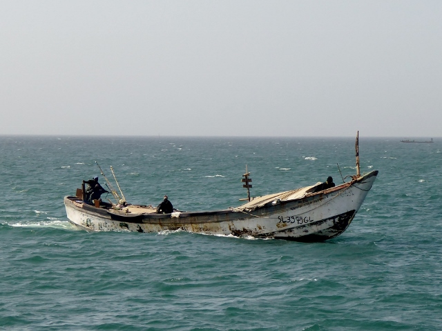 Passing a fishing boat as we return to Dakar on the mainland.