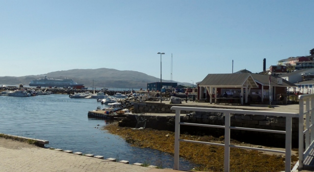 The fish maket is across the street and across the stream from the fountain.
