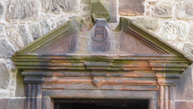 Signage on the lintel says "The Blessing of God be Herein."